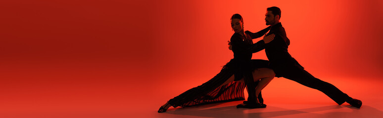 Silhouette of dancers moving on red background with shadow, banner