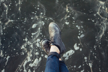 woman legs on water, from above, near the sea, hipster background