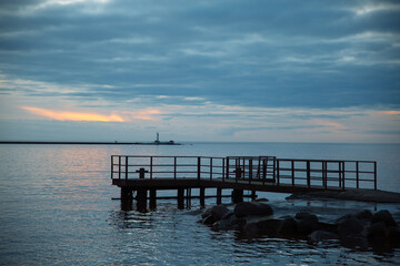 Fototapeta premium Pier platform in the sea, cloudy sunset, background image