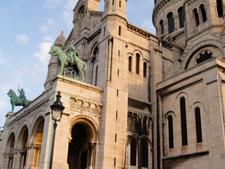 Fototapeta na wymiar Bronze equestrian statues of King Louis 1V guarding entrance to Sacre Coeur Cathedral