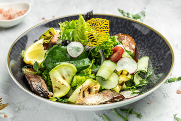 salad with smoked red fish with fresh vegetables, lettuce leaves on a white background, Restaurant...