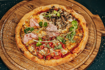 ready pizza on a wooden tray