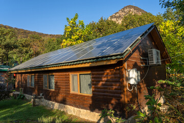Wooden house with solar panels on the roof