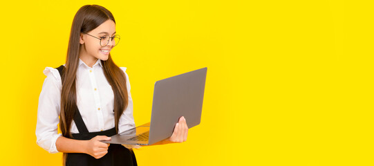 cheerful child study online. computer vision syndrome. nerd typing school blog. School girl portrait with laptop, horizontal poster. Banner header with copy space.
