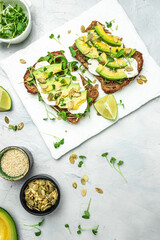 avocado toasts with cheese, pumpkin, nut and sesame. Healthy fats, clean eating for weight loss