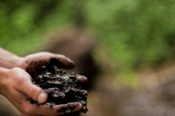 Soil in farmer hands with mud