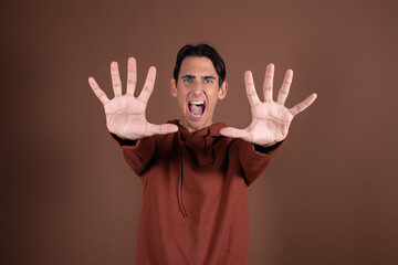Frightened guy posing in a photo studio. Fear and horror.