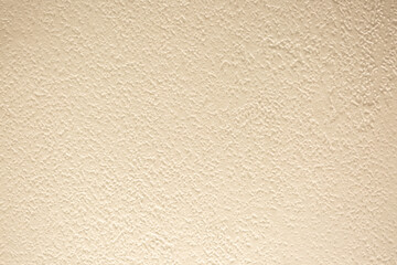 Brown background from decorative plaster with abstract spots. Unusual beige wall texture with beautiful patterns, creative surface background. Front covering for facing of buildings.