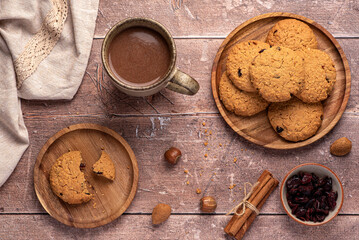 Food photography of oatmeal cookies, biscuits,  nuts, dried cranberries, cinnamon, chocolate, cocoa