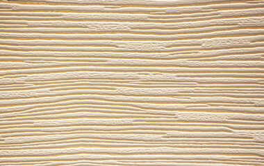 Brown background from decorative plaster with abstract spots. Unusual beige wall texture with beautiful patterns, creative surface background. Front covering for facing of buildings.