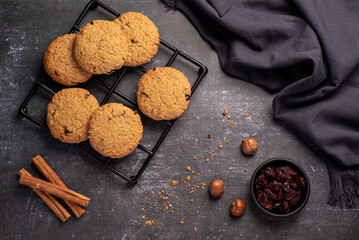 Food photography of oatmeal cookies, biscuits,  nuts, dried cranberries, cinnamon