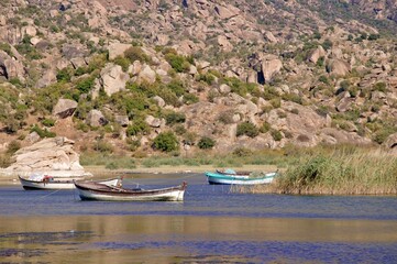 Obraz premium Fishing boats moored along the shore of Lake Bafa in Turkey.