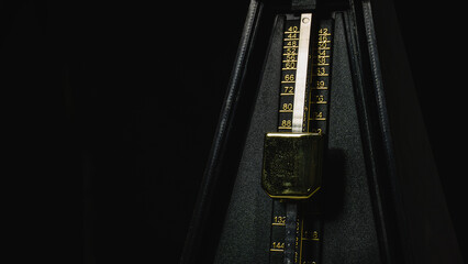 Mechanical metronome on a dark plain background: music, mechanical metronome, metronome, dark,...
