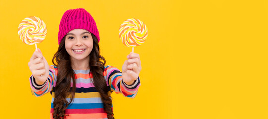 happy kid girl hold lollipop sweet, selective focus, candy shop. Teenager child with sweets, poster...