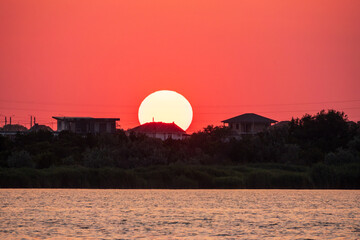 The sun goes down over a lake