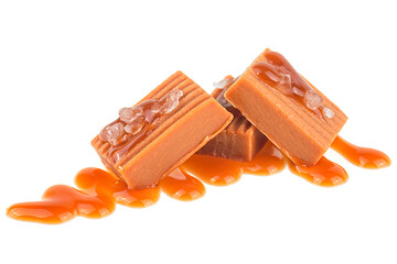 Caramel candies with caramel sauce and sea salt isolated on a white background. Toffee candies.