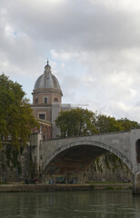 Fototapeta na wymiar The Saint Angelo bridge spanning the Tiber river in Rome Italy as seen on a fall day.