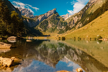 Fototapeta na wymiar The Saentis summit in the background with reflections at the famous Seealpsee lake, Innerrhoden, Appenzell, Alpstein, Switzerland