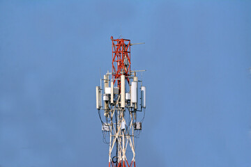Telecommunication antenna tower with satellite dish and internet tower on blue sky background 