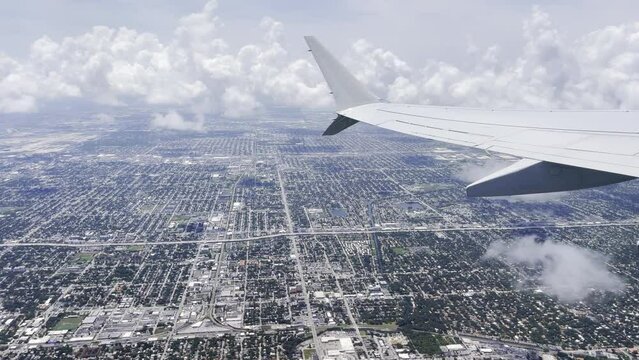 Airplane flying over Miami after taking off from Miami airport, Florida, USA