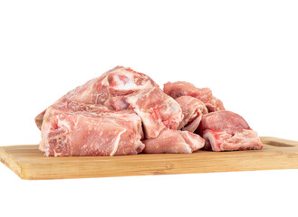 Pork meat on a wooden cutting board isolated on white background.