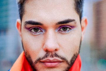 Nonbinary gay person with makeup on looking at camera outdoor - LGBTQ drag queen concept