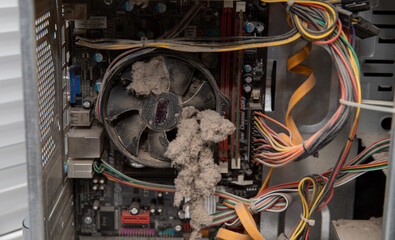 There is a lot of dust in the computer. Computer prevention. Dirt and dust on the boards, housing and wires.