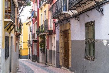 Fototapeta premium old colorful buildings in the historic center of Villajoyosa. Narrow streets and colorful tenement houses