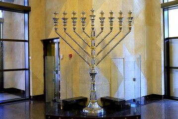 Golden Hanukkah menorah in the synagogue for Jewish holiday. Ancient ritual religious menorah...