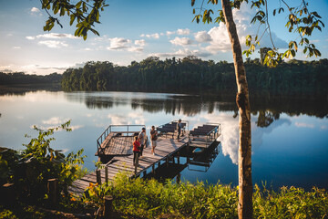 dock on the lake surrounded by boats and tourists
