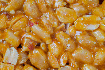 Top view: caramelized nuts fried in honey - Gozinaki - orange granola peanut bar - close up, macro....