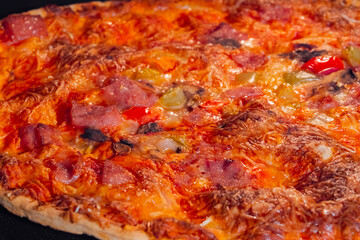 Obraz na płótnie Canvas Burnt pizza with ham, mushroom, pepper, cheese on tray in electric oven - close up view, macro. Italian cuisine, failure, problem, homemade bakery, fast food concept