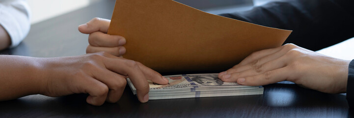 Asian businesswoman taking bribes to nonviolent officials Sign a business project contract put...