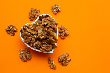 bowl full of almonds on a colored background