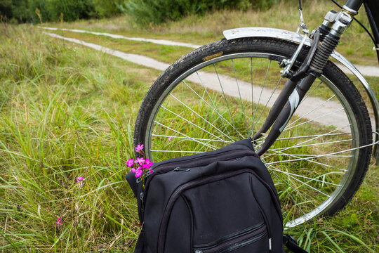 While the tourist is resting…
Bicycle and backpack by the meadow road.
