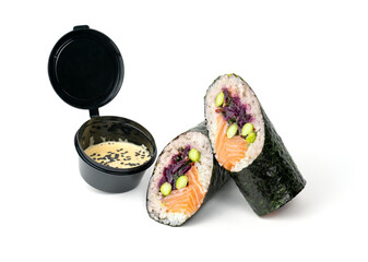 Sushi burrito rolls, sandwich with red cabbage, salmon, rice, beans edamame wrapped in nori and bowl of sauce on a white background.