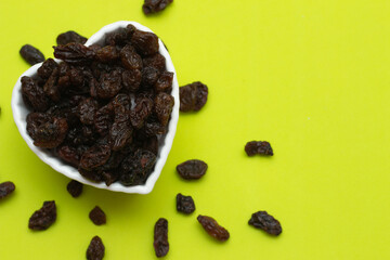 bowl full of raisins on a colored background
