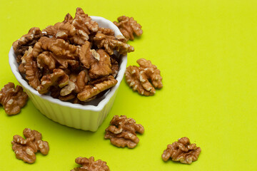 bowl full of almonds on a colored background
