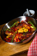 Fried chicken legs with various vegetables and spices