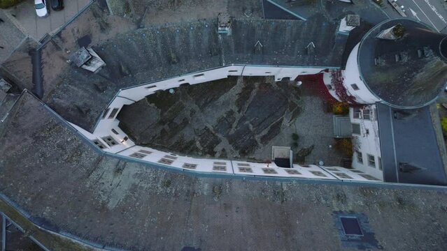 Aerial drone Shot in Clervaux castle on the north of Luxembourg. Twilight evening scene with top view bird eye