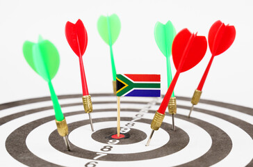 Darts with the flag of South Africa in the bullseye, next to red and green darts.