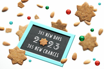 New year 2023, 365 new days, 365 new chances text. Levitation of star cookies and chocolate balls...