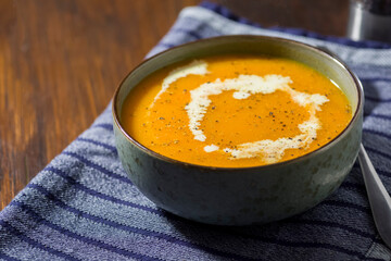 Pumpkin soup strewn with cream, seasoned with pepper