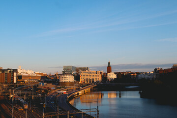 Fototapeta na wymiar Sunset over the river in Stockholm. Traffic in the city.