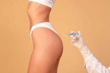 Non-sugical butt lifting sculptra concept. Side view of young woman getting hip injection at...