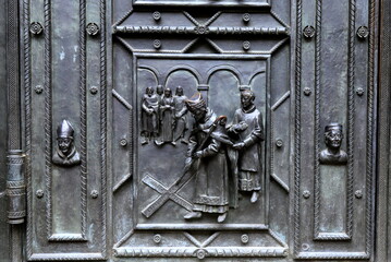 Prague Castle, Czech Republic, St. Vitus Cathedral, figures with scenes of medieval life on door cathedral.