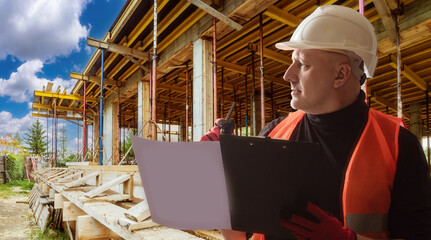 Civil engineer. Man engineer at construction site. Engineer draws up construction plan. Large Country building behind builder. Man in construction uniform and helmet. Engineering company employee