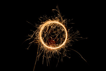 Sparks from the circular rotation of lights on a black background
