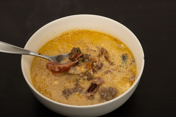 Cheese Burger Soup with ground beef cheese and a white bowl