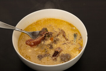 Cheese Burger Soup with ground beef cheese and a white bowl